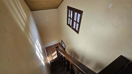 Rustic interior stairway with wood panels and natural light mountain home Panama