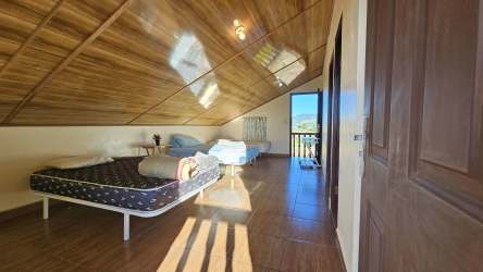 Loft bedroom with wooden ceiling, access to balcony and mountain views Tierras Altas Panama