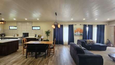 Large covered terrace overlooking garden and mountains in Volcan Tierras Altas house