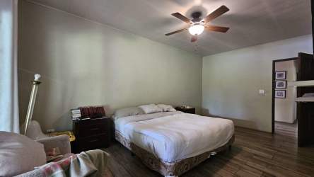 Spacious bedroom with large windows overlooking nature in Volcan house Panama