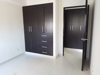 Second bedroom with wardrobe and large window in MIDRISE Woodlands Panama Pacifico