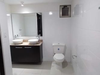 Bright bathroom with double sink vanity and large mirror MIDRISE Woodlands Panama