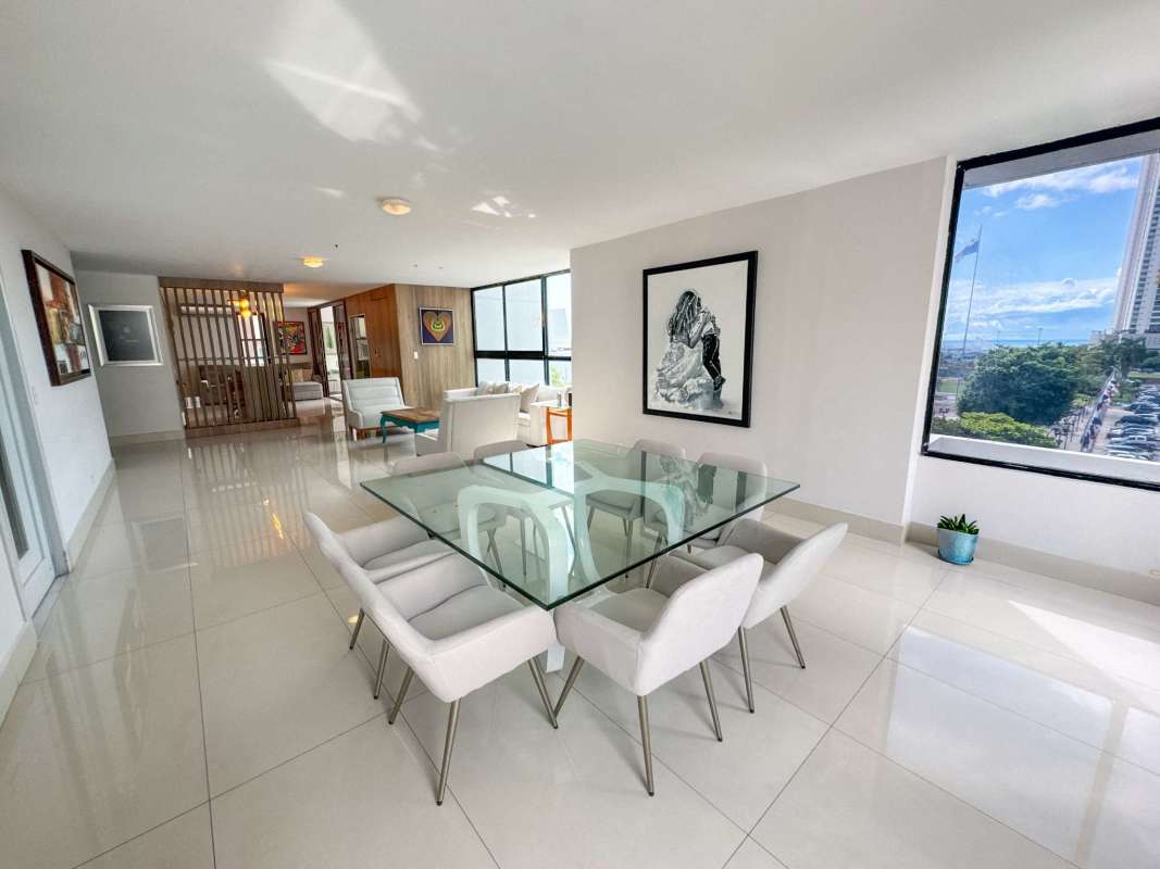 Open living dining area with large windows and city skyline view at PH Coral Bay San Francisco Panama