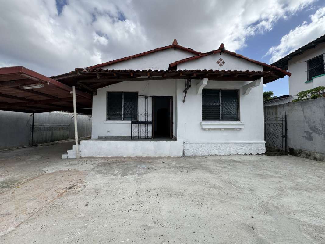 Parking lot area inside commercial lot with concrete surface and gated walls in Panama City
