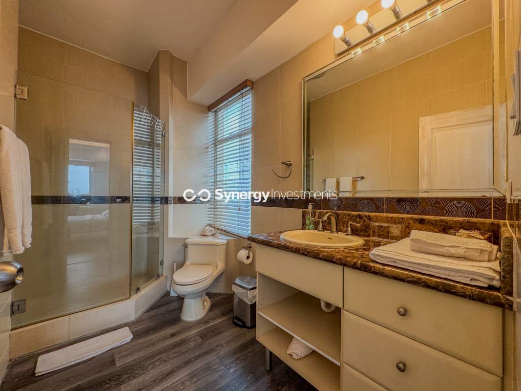Modern bathroom with glass-enclosed shower, marble vanity PH BICSA Avenida Balboa Panama City