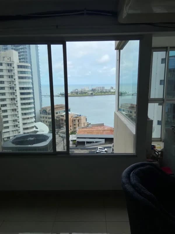 Large window view overlooking Panama City skyline with ocean in background from PH Las Perlas