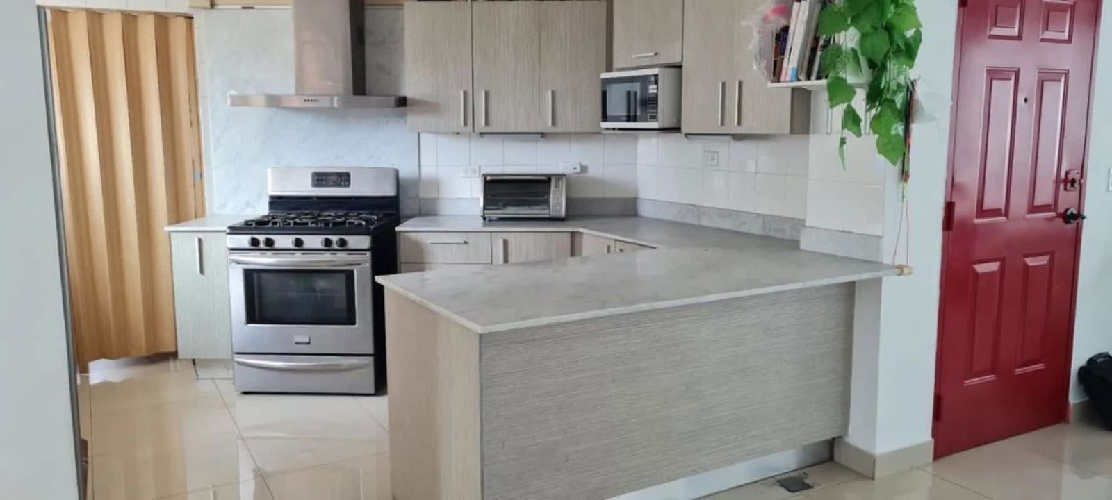 Bedroom featuring closet storage, large window with Panama City skyline view at PH Las Perlas Punta Paitilla