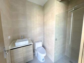 Modern bathroom with glass walk-in shower luxury finishes Playa Escondida Marina condo Panama