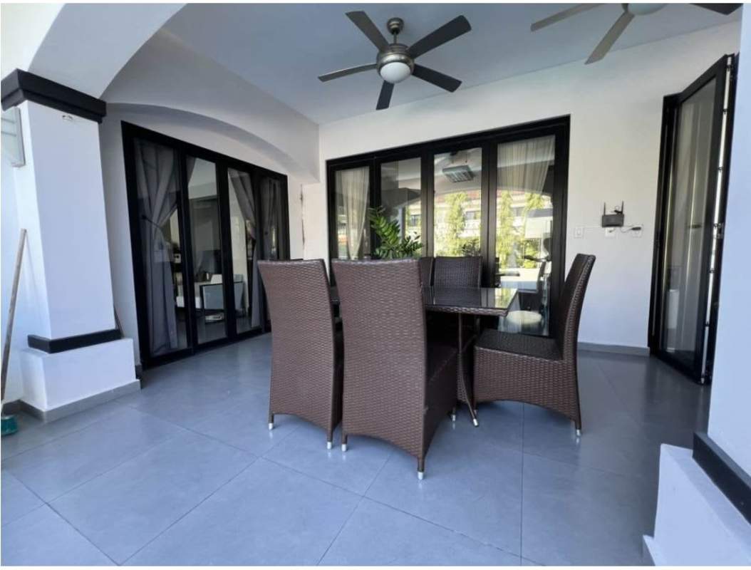 Outdoor terrace with seating and ceiling fans overlooking garden and pool in Panama
