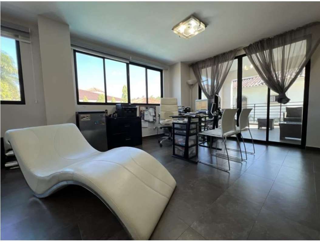 Rounded staircase with iron railing and chandelier in Costa del Este villa for rent Panama