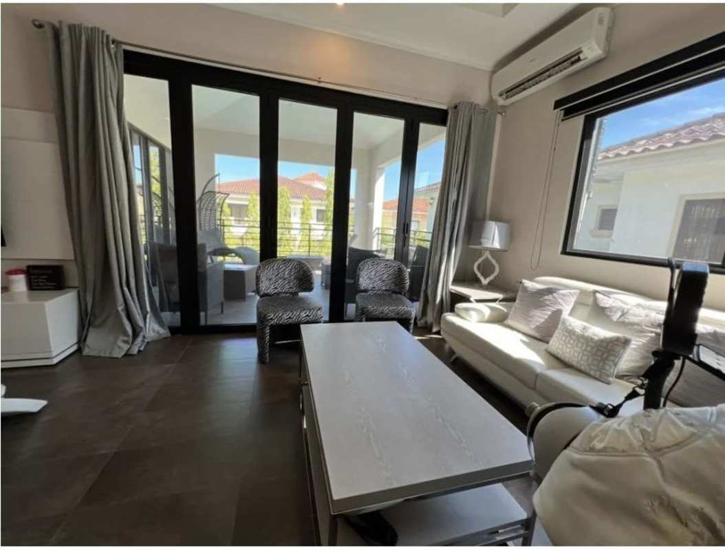 Living room with large sliding doors leading to balcony Costa del Este rental Panama