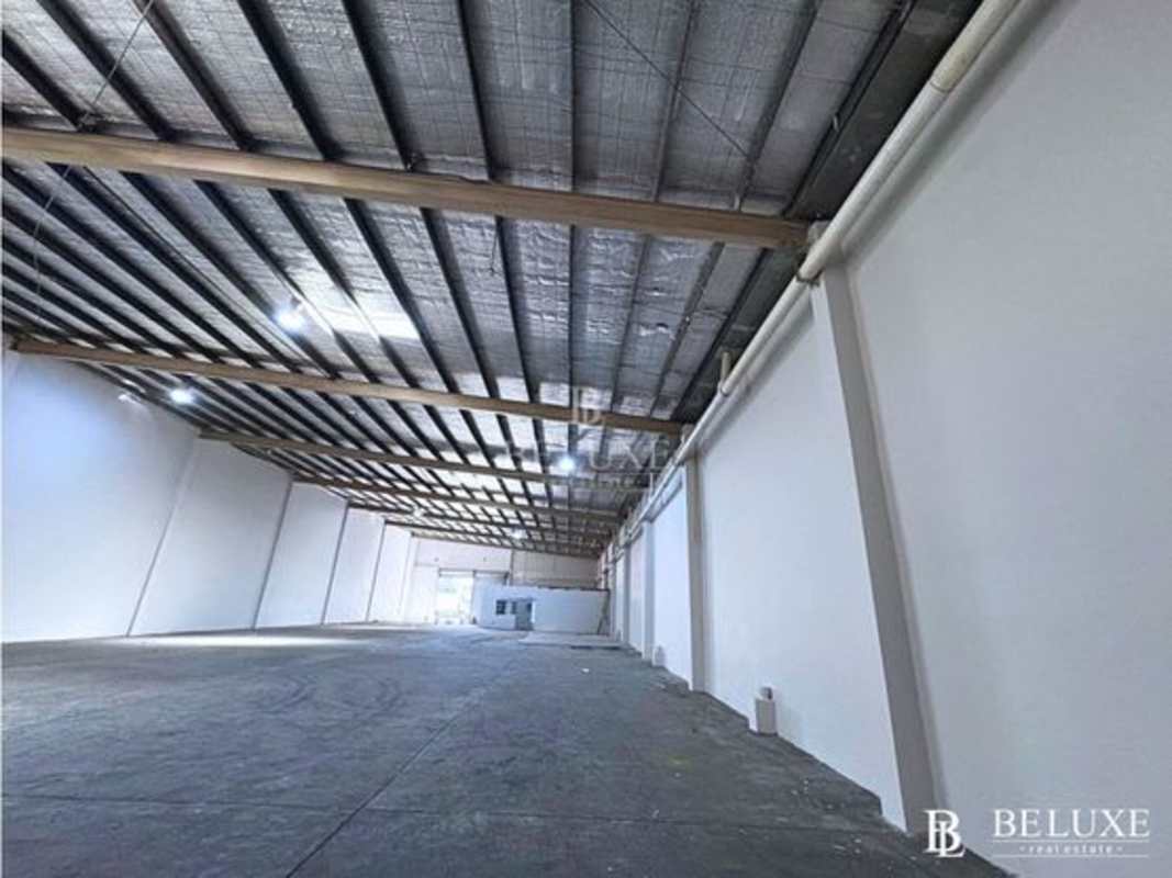 Main entry gates of industrial warehouse complex with paved driveway in Panama