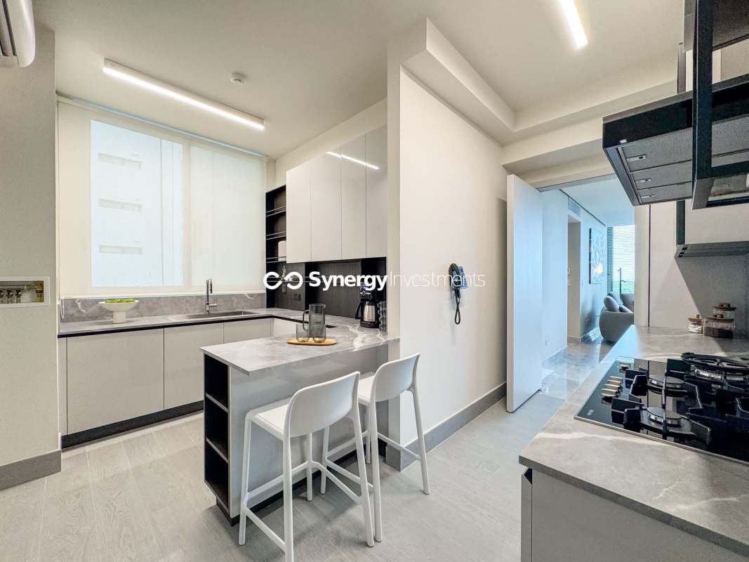 Open living and dining room with marble flooring at PH The Reserve Santa María