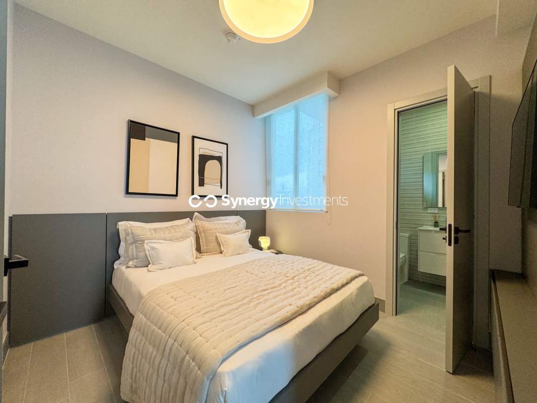 Modern bathroom with marble, double sink and glass shower in Panama City condo