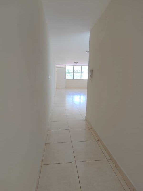Bright hallway with tiled flooring leading to living room in apartment Bethania Panama