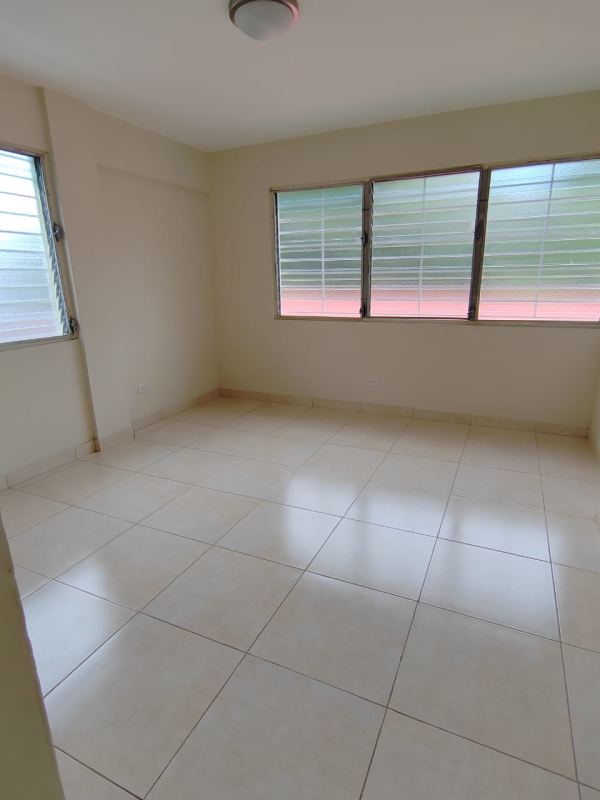 Empty bedroom with large windows tiled floor in Bethania apartment Panama