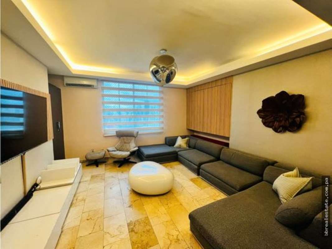 Modern dining and living area with balcony access in penthouse at PH Costa Pacifica Punta Pacifica Panama