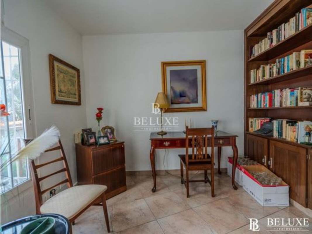 Spacious kitchen with granite countertops and wood cabinetry in Dos Mares luxury villa for sale