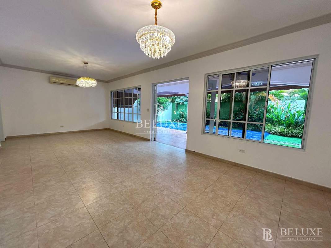 Large tiled living room with windows opening to garden in PH Palmera del Este for rent Panama City
