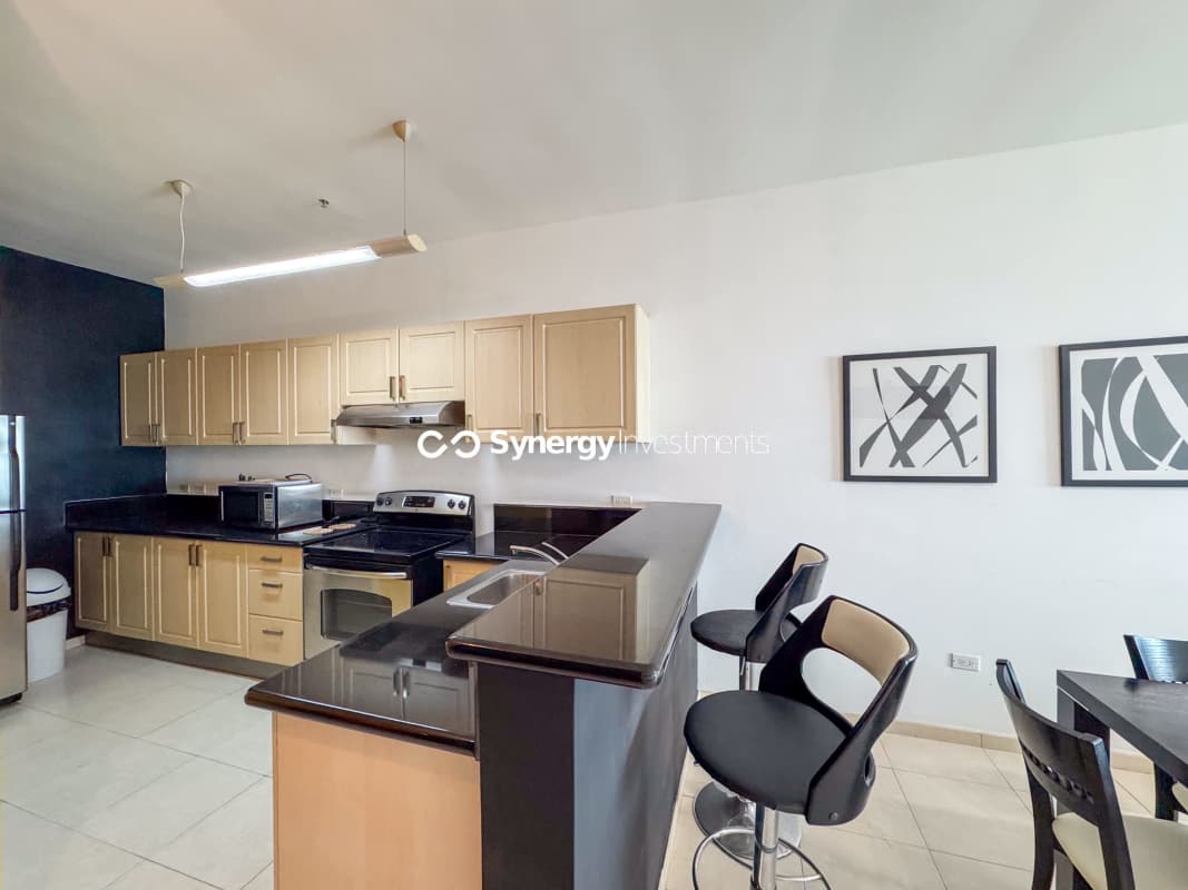 Spacious master bedroom with balcony access, sea views, contemporary decor in PH Yacht Club Panama