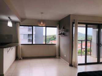 Bright living room with balcony access in condo Panama Pacifico Woodlands