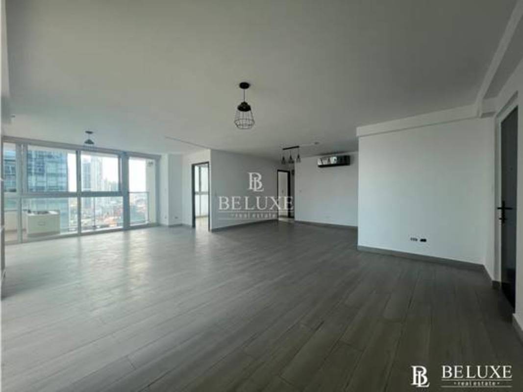 Bedroom with panoramic windows overlooking Panama City skyline in PH Belle View Tower Panama