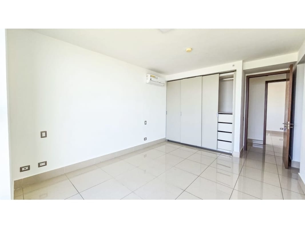 Bedroom with large windows and city view in PH Bali Costa del Este Panama