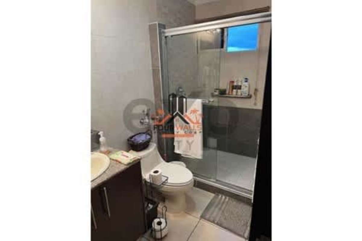 Open-plan living dining area with large window and stone accent wall in PH Constellation Panama