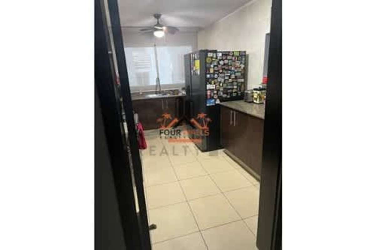 Contemporary kitchen granite countertops dark cabinets ceiling fan at PH Constellation Panama