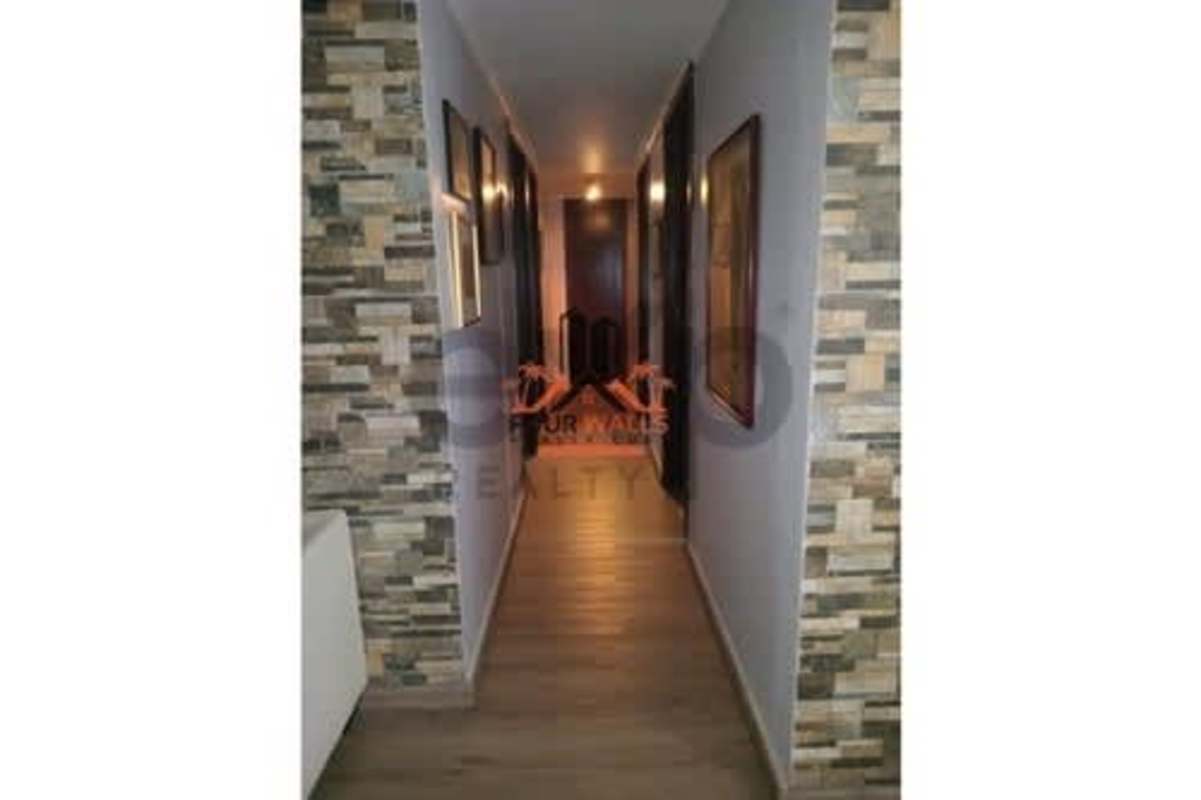 Modern hallway with accent stone wall and warm lighting at PH Constellation Panama