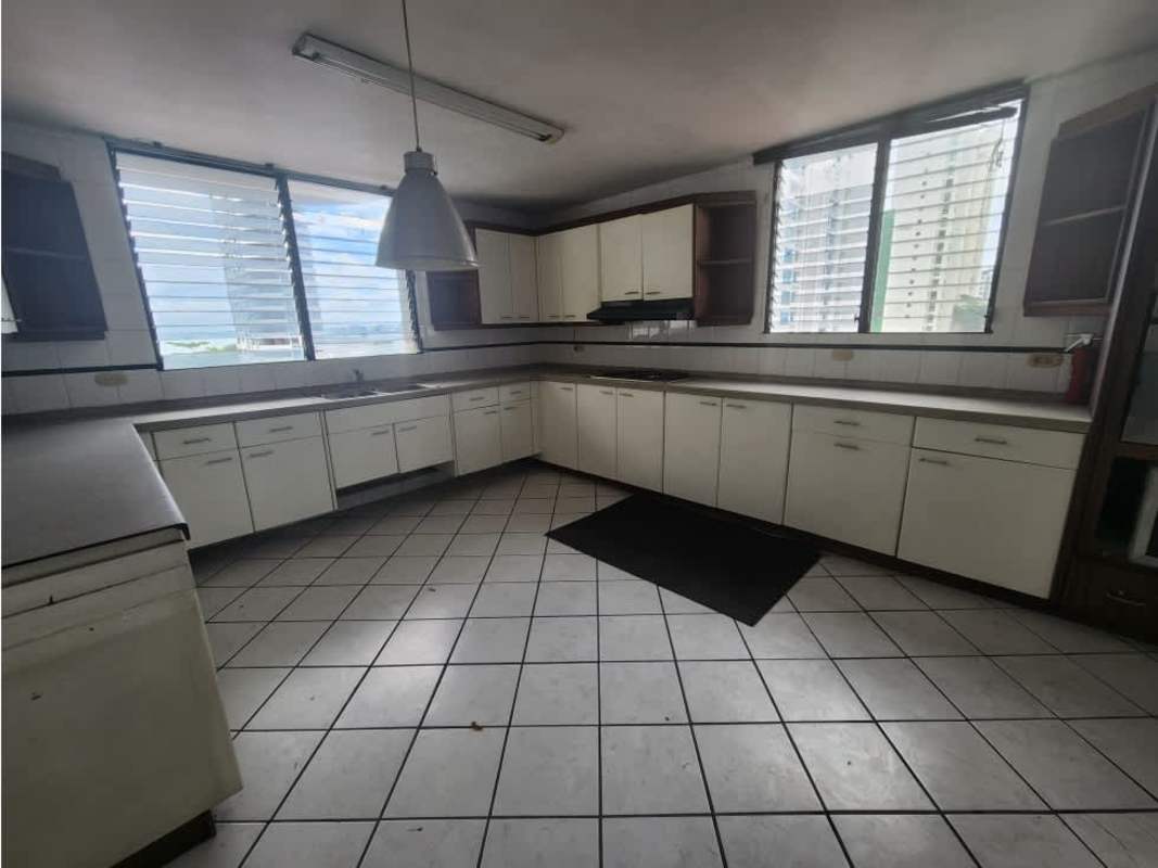 Apartment kitchen with multiple windows, white cabinetry and tile PH Waterfront Coco del Mar Panama City