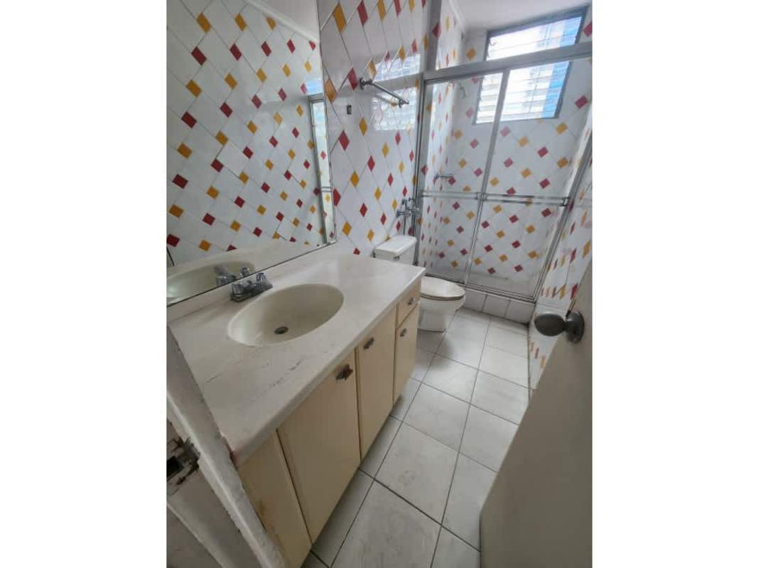 Penthouse bathroom with colorful tile walls, mirror and enclosed shower PH Waterfront Panama City