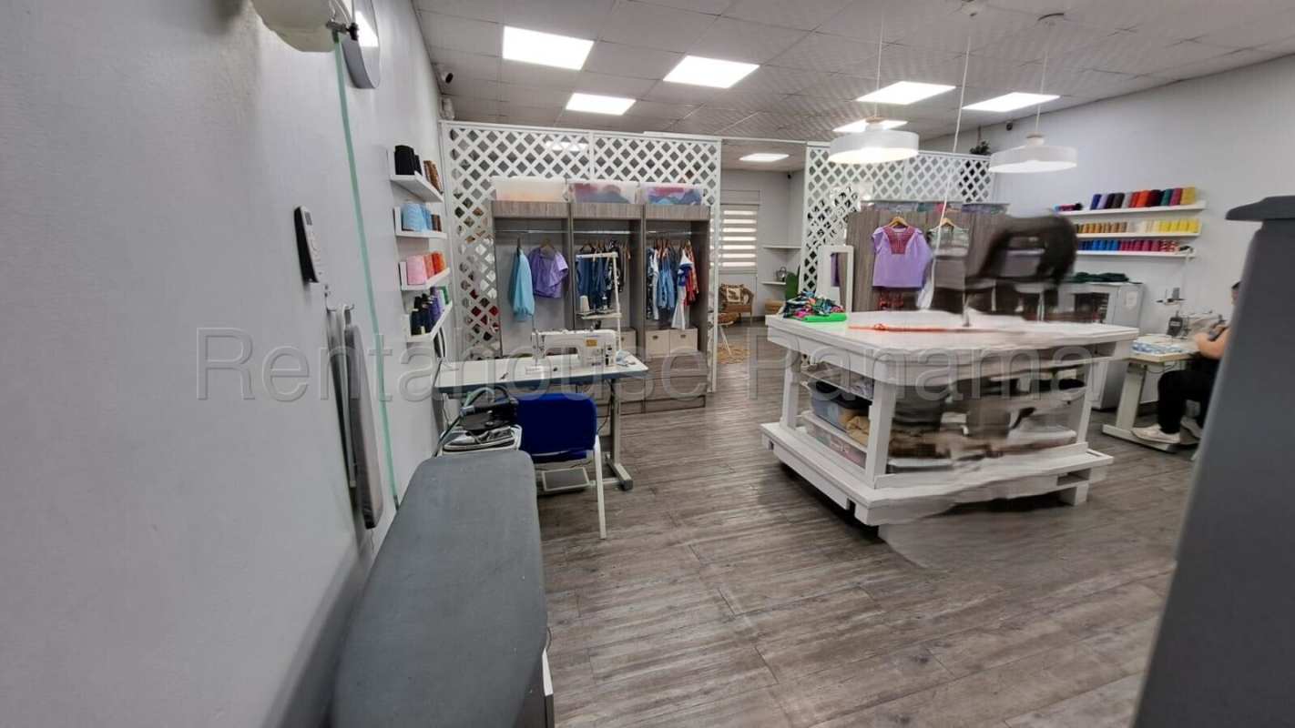 Interior retail showroom with partition walls and clothing racks in San Francisco Panama