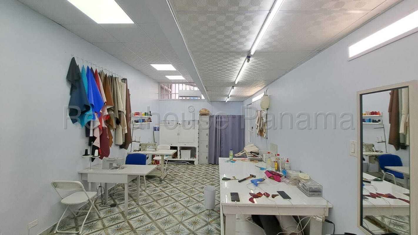 Sewing workshop interior with fabrics, tables and bright lighting in commercial space Panama