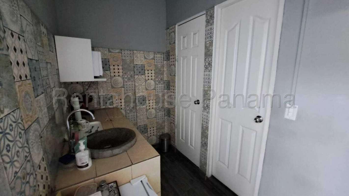 Eclectic bathroom with patterned tiles, vanity cabinet and vessel sink in San Francisco Panama