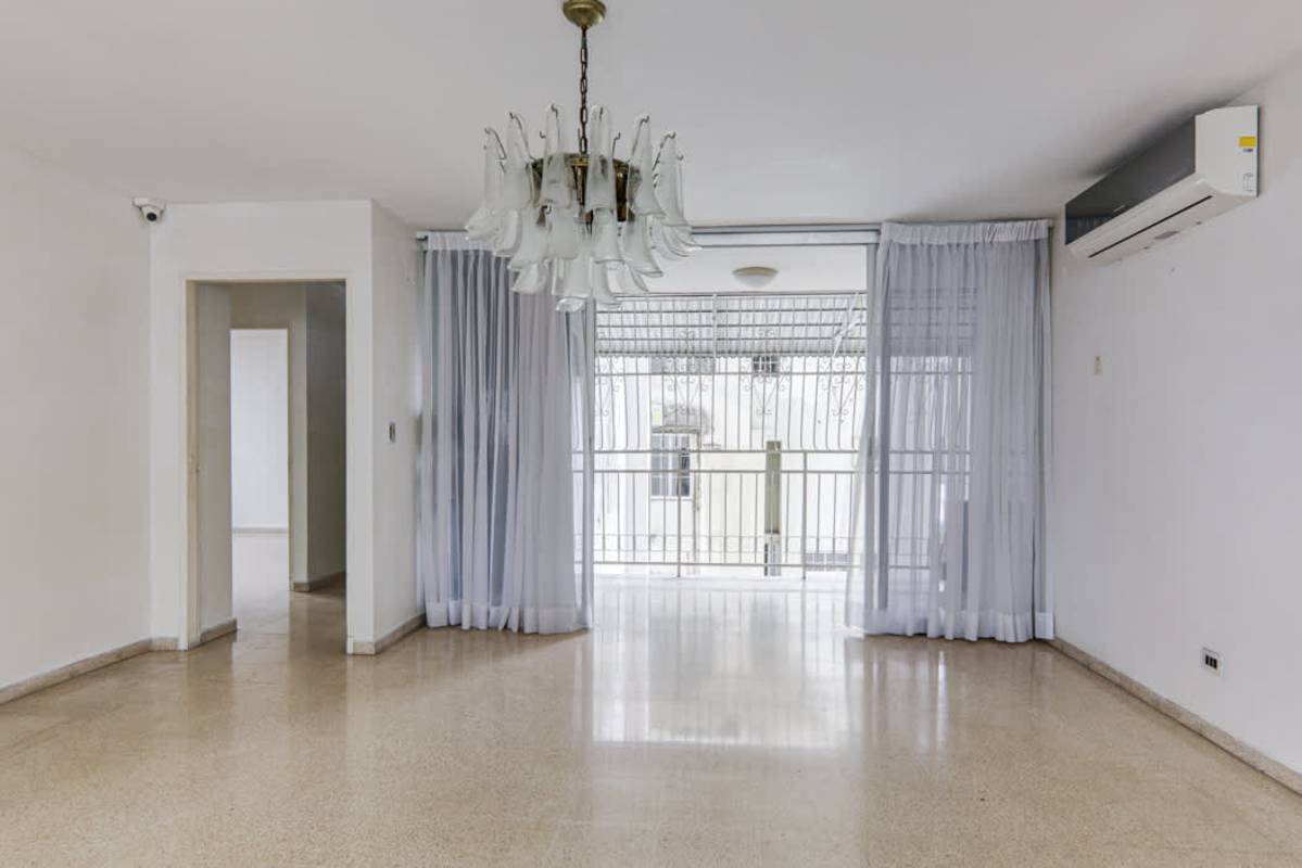 Bright living room with floor-to-ceiling windows and tile floors in PH Marina Plaza Marbella Panama