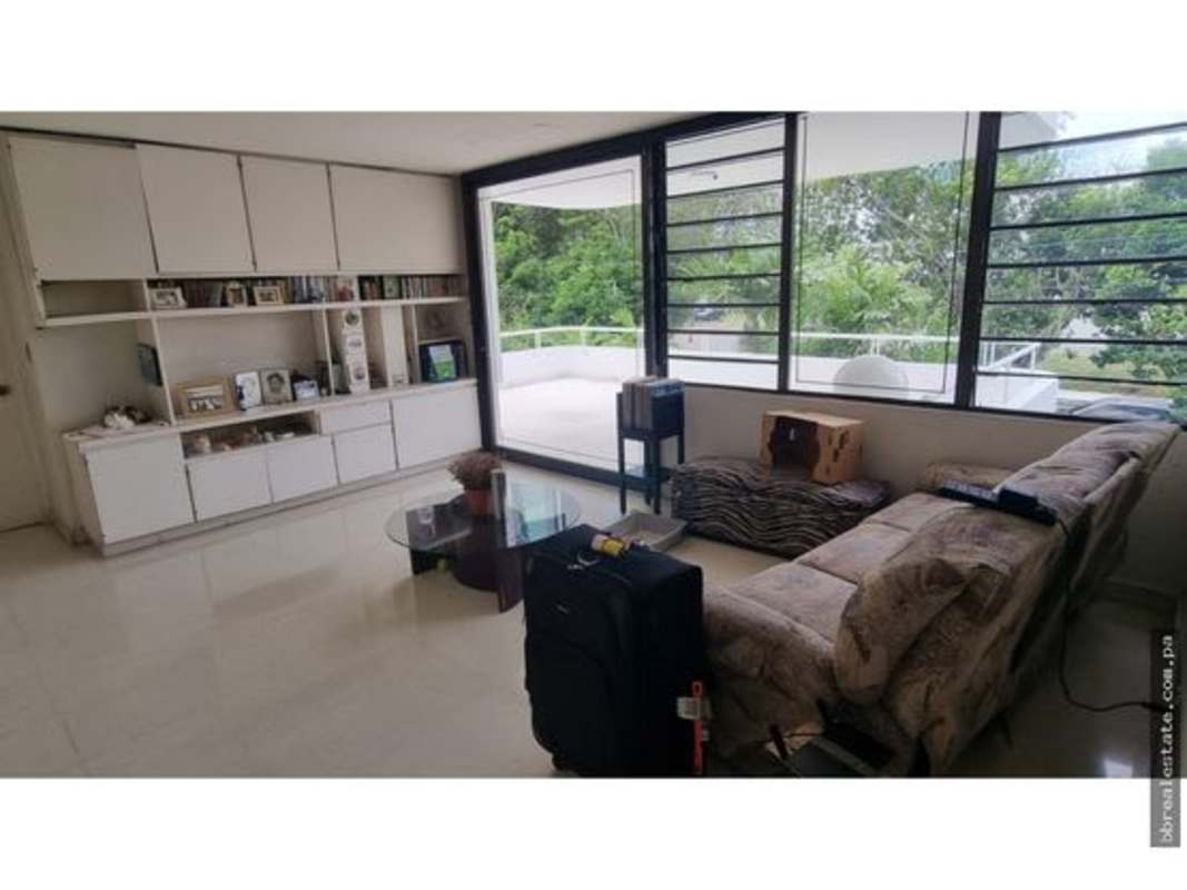 Open concept living dining space with large windows in mixed-use house rental Panama City
