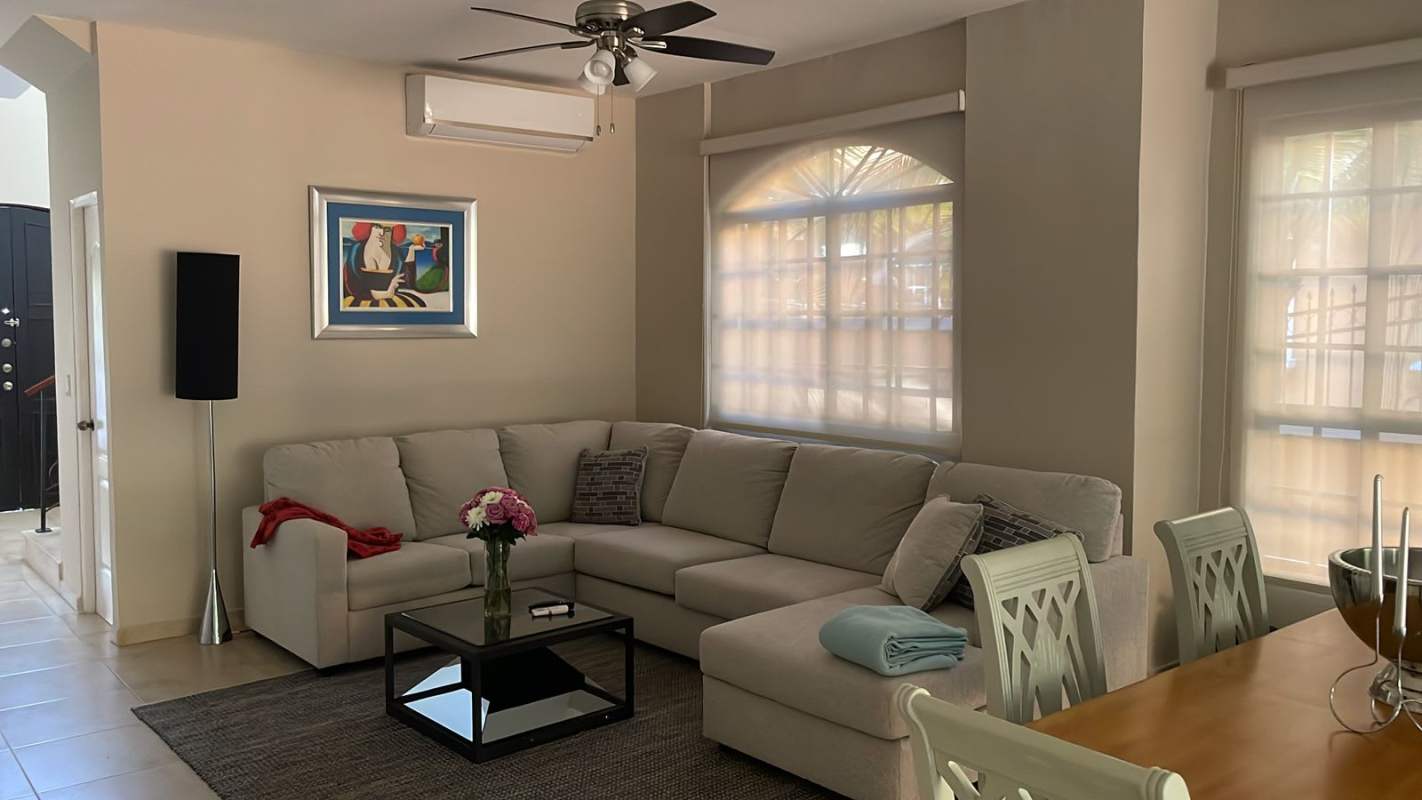 Living room with dining and terrace access in furnished Clayton Village Panama rental home