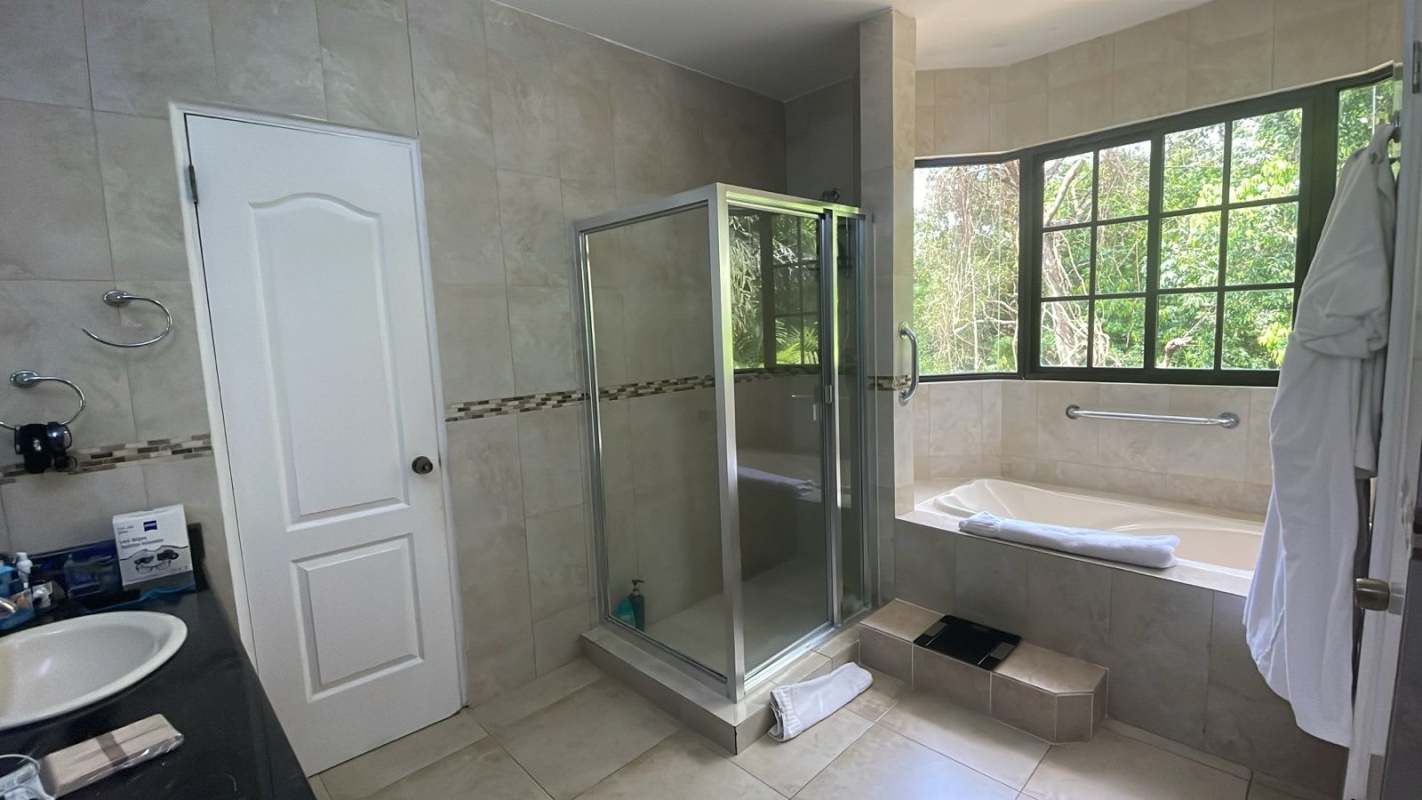 Spacious bathroom with large tub, glass shower, double sinks in Clayton Village house rental