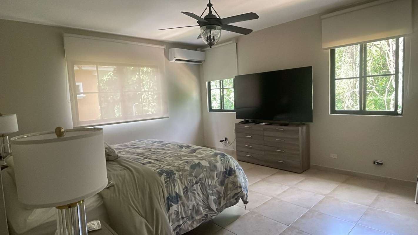 Bedroom with king bed, large windows, TV, AC, ceiling fan furnished rental Clayton Panama