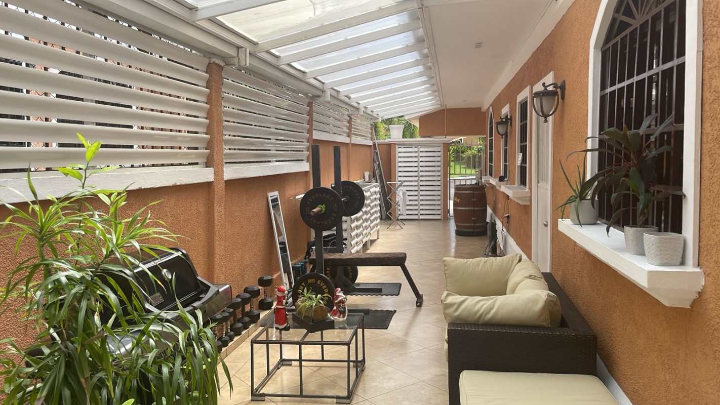 Outdoor patio with hammock, ceiling fan, BBQ area in Clayton Village Panama rental home