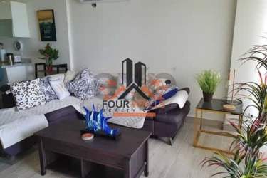 Contemporary kitchen with granite countertop and breakfast bar at Sanctuary Tower Playa Caracol