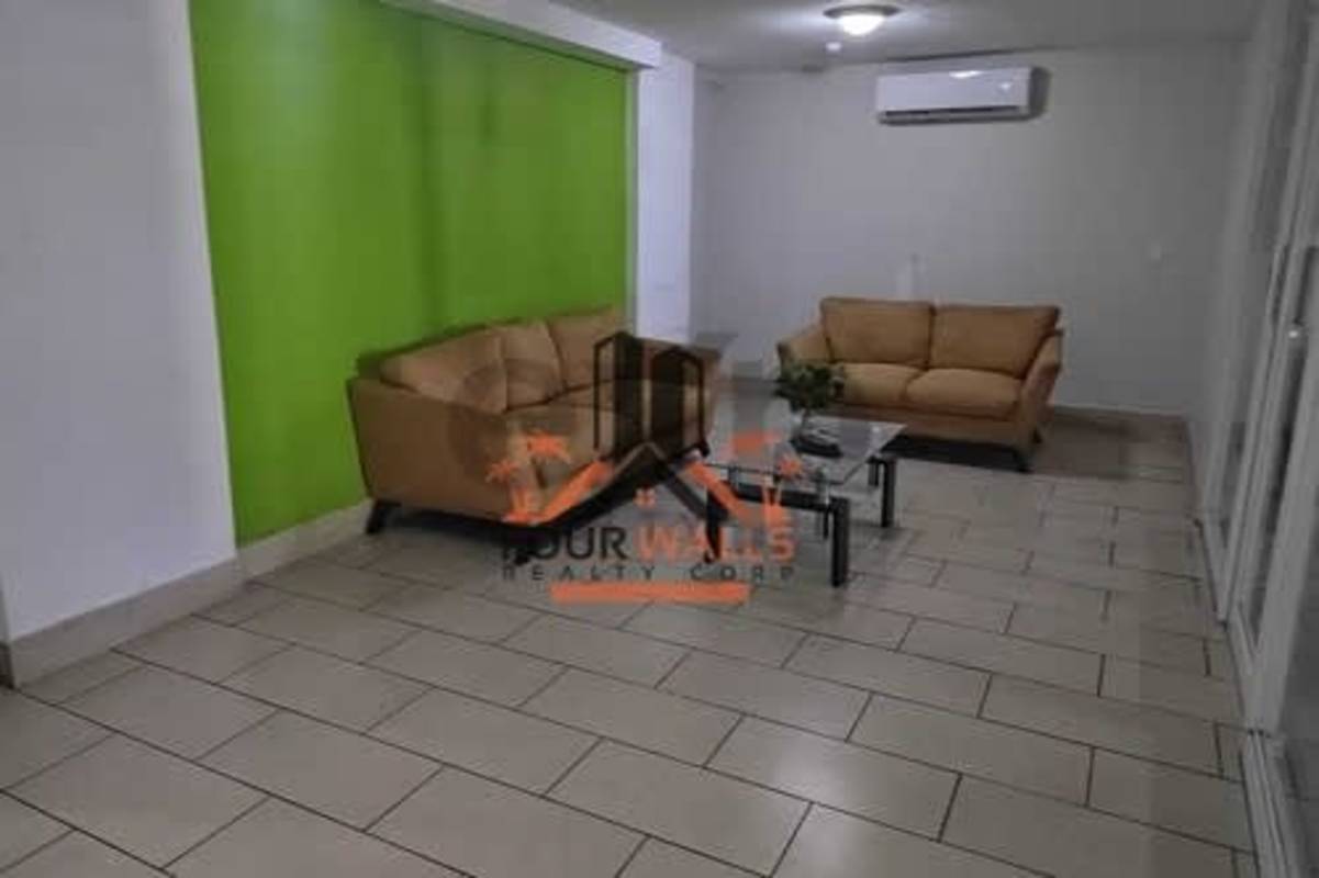 Living room with green accent wall beige sofas tile floor PH Met View Betania Panama