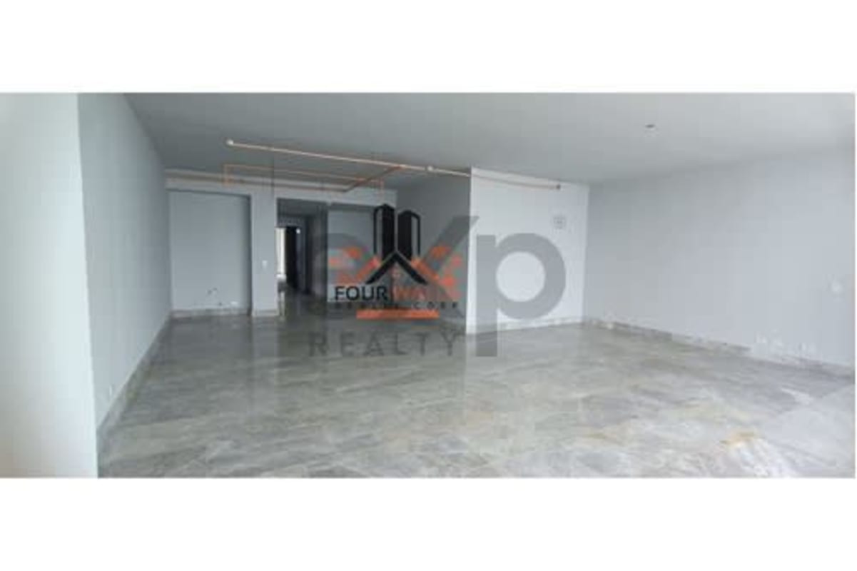 Marble floor living room with large panoramic windows overlooking ocean in PH The Towers Panama