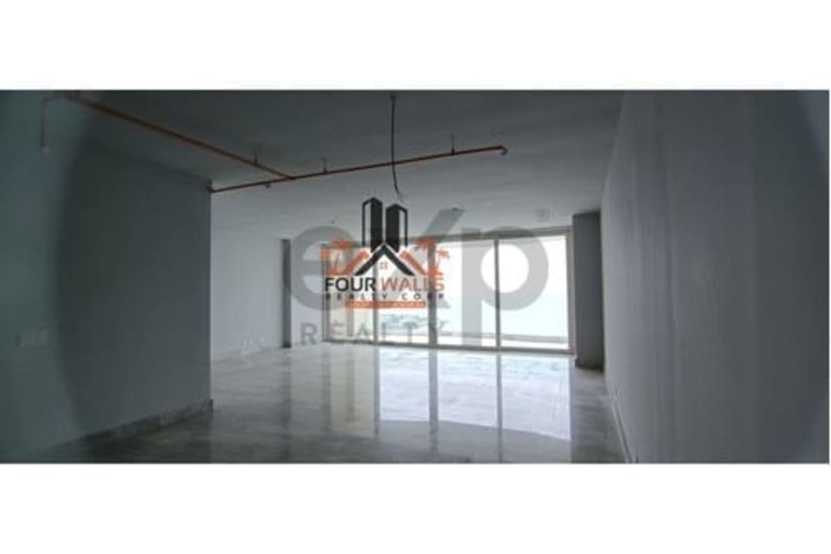 Unfurnished living room with large windows, marble floors at PH The Towers Punta Paitilla Panama City