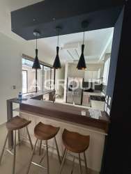 Contemporary open kitchen with appliances and breakfast bar in Panama Pacifico home