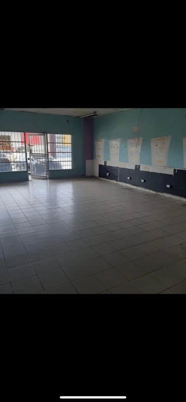 Spacious open commercial interior with tiled floor and security barred windows at PH Rio Plaza Panama