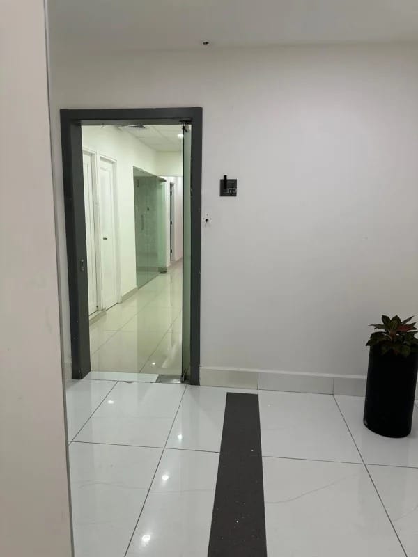 Office entry with glass door and minimalist decor at Panama Design Center Obarrio