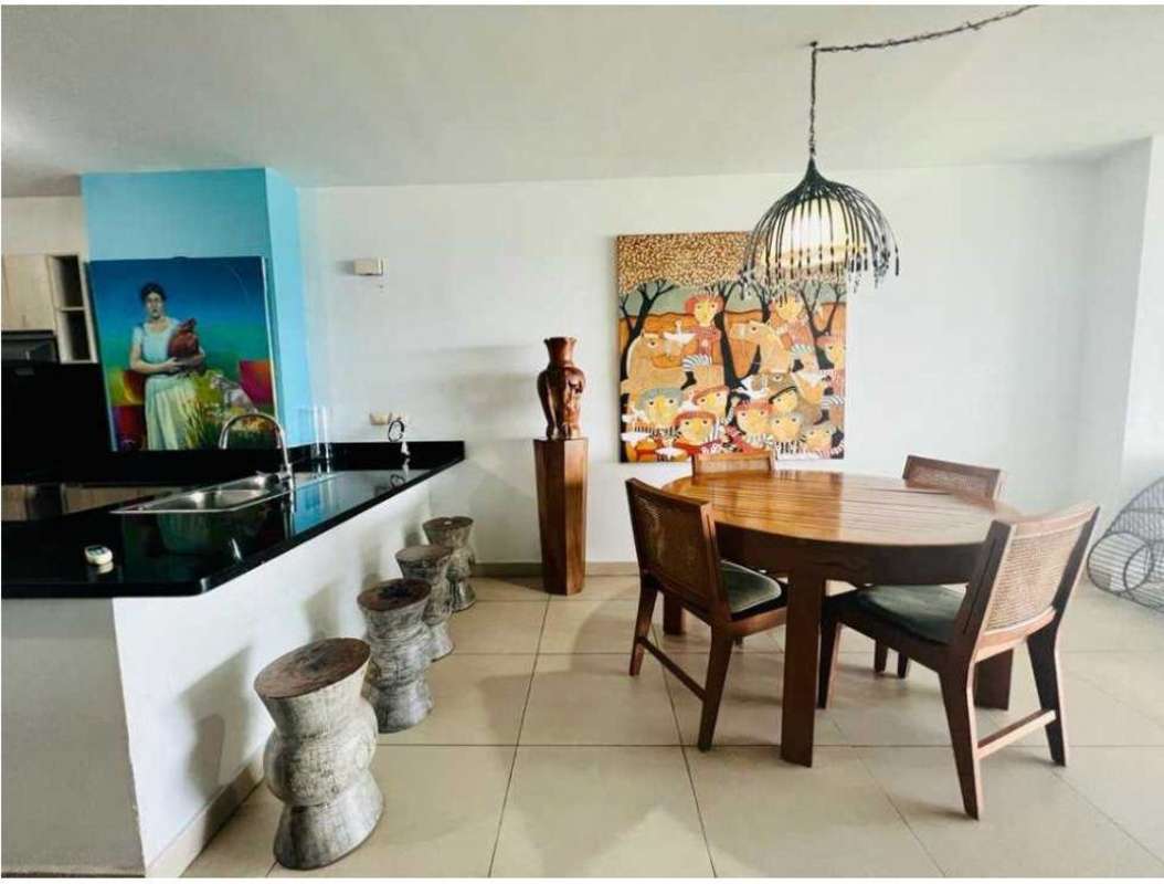 Dining space with open kitchen modern furnishings and decor at PH Rivage Tower apartment for rent.