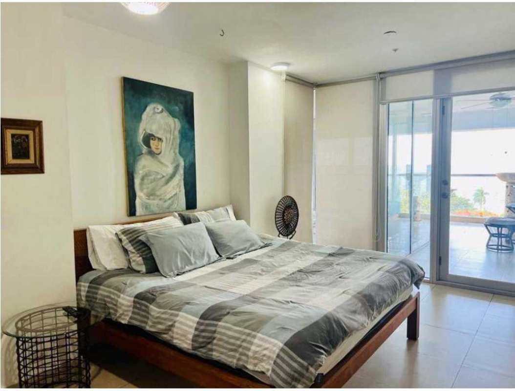 Bedroom with large glass doors and modern designer decor open to terrace PH Rivage Tower